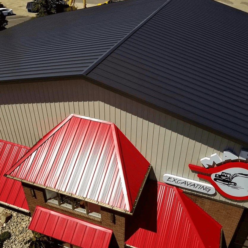 An aerial view of a building with a red front roof